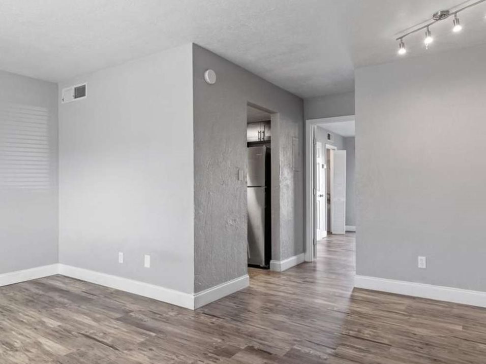 A room with wooden flooring and a white ceiling.